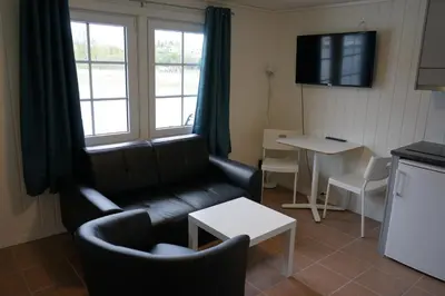 a living room with a couch and a table at Orkla Camping in Orkanger