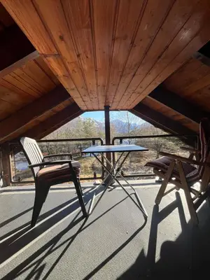 a table and two chairs sitting on a porch at Bua in Viksdalen