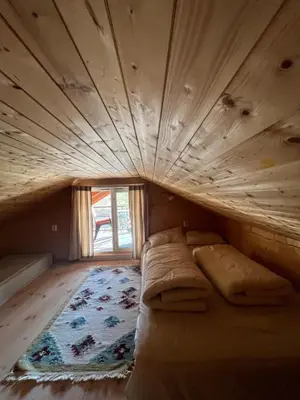 a bed in a room with a wooden ceiling at Bua in Viksdalen