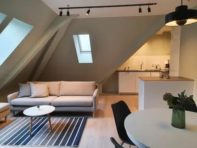 a living room with a couch and a table at Kong Oscars Apartments in Bergen