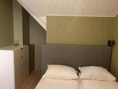 a bed with two white pillows in a bedroom at Kong Oscars Apartments in Bergen