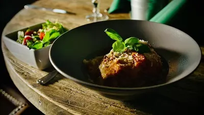 a bowl of food on a table with a salad at Fosen Fjord Hotel in Å i Åfjord