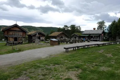 a road in front of a group of wooden buildings at Fjelltun Fritidsleiligheter, leilighet 407 in Geilo