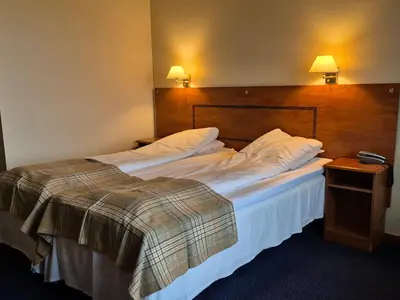 a large bed in a hotel room with two pillows at Westland Hotel in Lindås