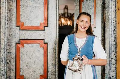 a young woman holding a silver vase at Utne Hotel in Utne