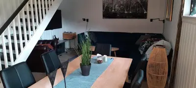 a living room with a table and a couch at Ålfotevegen 5 in Ålfoten