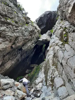 a person climbing up a rocky mountain at Ålfotevegen 5 in Ålfoten