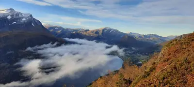 a view of a valley of clouds in the mountains at Ålfotevegen 5 in Ålfoten