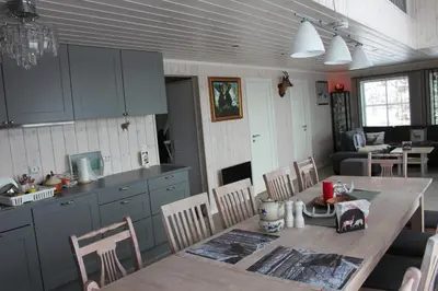 a kitchen and dining room with a table and chairs at Luxury Mountain Villa in Strandlykkja