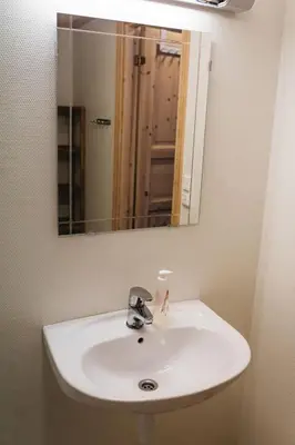 a white sink in a bathroom with a mirror at Hovdehytta in Hovden