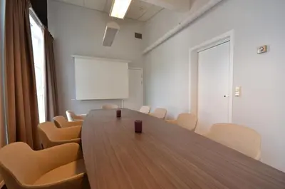 a conference room with a wooden table and chairs at Grand Hotel - by Classic Norway Hotels in Åndalsnes
