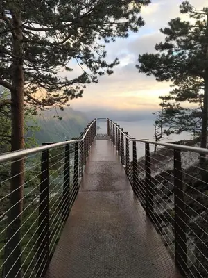 a bridge over a mountain with a view of the ocean at Grand Hotel - by Classic Norway Hotels in Åndalsnes
