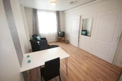 a living room with a white table and chairs at Systra Hotel Søvik in Syvik