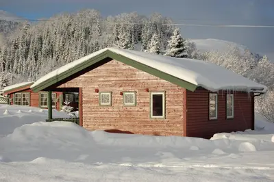 a small house with snow on the roof at Fjellstova Ørskogfjellet Cottages in Sjøholt
