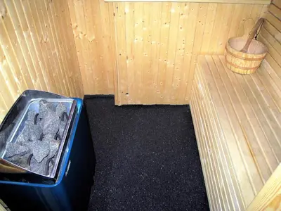 a room with a bin of rocks and a wooden wall at Alpin Apartments Sørlia in Hafjell