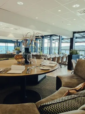 a dining room with a table with wine glasses at Panorama Hotell & Resort in Steinsland