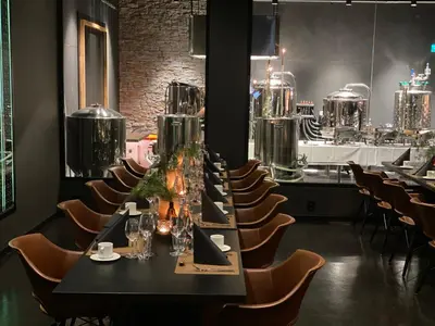 a long black table and chairs in a room at Panorama Hotell & Resort in Steinsland