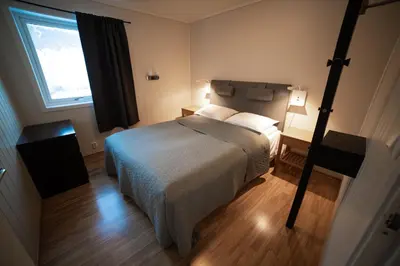a bedroom with a large bed and a window at Førde Gjestehus og Camping in Førde