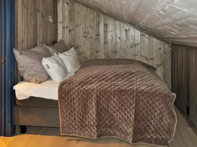 a bed with a blanket on top of it at 5 person holiday home in Fåvang-By Traum in Favang