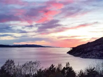 a sunset over a body of water with a cloudy sky at 8 person holiday home in Masfjordnes-By Traum in Masfjorden