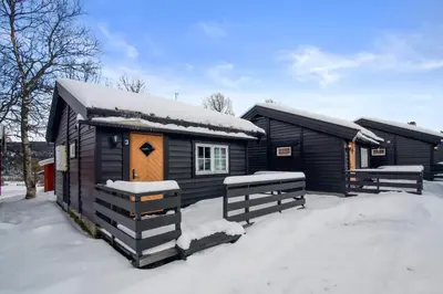 a small cabin with snow on the roof at Øen Turistsenter Cottages in Geilo