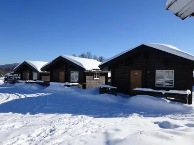 a group of lodges covered in snow at Øen Turistsenter Cottages in Geilo
