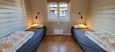 two beds in a room with a window at Øen Turistsenter Cottages in Geilo