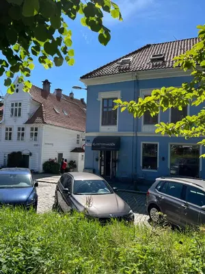 two cars parked in front of a building at Klosterhagen Hotel in Bergen