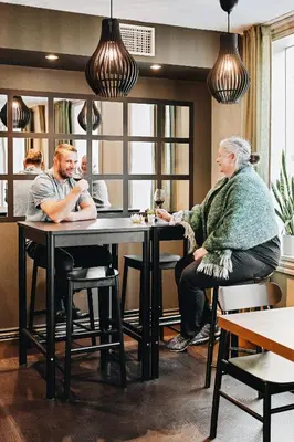 a man and a woman sitting at a table at Klosterhagen Hotel in Bergen