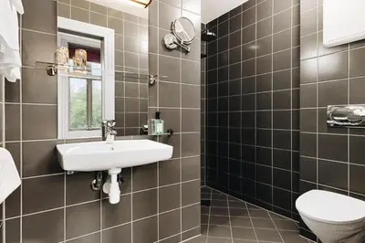 a bathroom with a sink and a toilet at Klosterhagen Hotel in Bergen