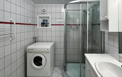 a bathroom with a washing machine and a shower at 3 Bedroom Cozy Home In Lavik in Lavik