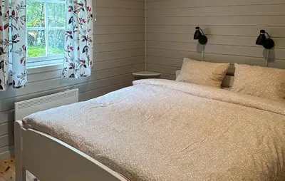 a bedroom with a bed and a window at 3 Bedroom Cozy Home In Lavik in Lavik