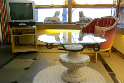 a living room with a table and a tv at Hardanger Feriesenter Nesvika in Norheimsund