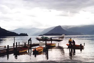 a group of people standing at a dock with boats at Hardanger Feriesenter Nesvika in Norheimsund
