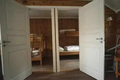 a room with two bunk beds and a door at Lesjaskogsvatnet Camping in Lesjaskog