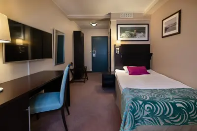 a hotel room with a bed and a desk at Quality Hotel Florø in Florø
