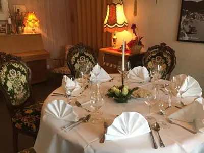 a table with glasses and napkins on a white table at Eikum Hotel in Hafslo