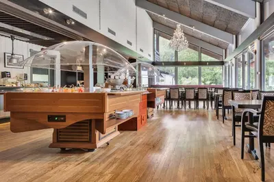 a restaurant with a bar with tables and chairs at Nordfjord Hotell in Nordfjordeid
