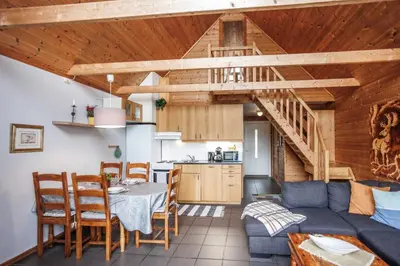 a living room with a blue couch and a table at Eastside Cottages in Bømlo