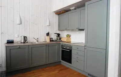 a kitchen with gray cabinets and a sink at Cozy Home In Lillehammer With Wifi in Lillehammer