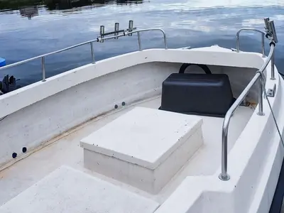 a white boat with a bench in the middle of the water at 6 person holiday home in Aukra in Aukra