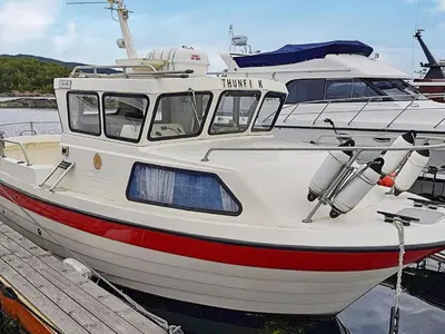 a boat is docked at a dock in the water at 6 person holiday home in Aukra in Aukra