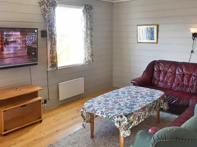 a living room with a couch and a table at 6 person holiday home in Aukra in Aukra