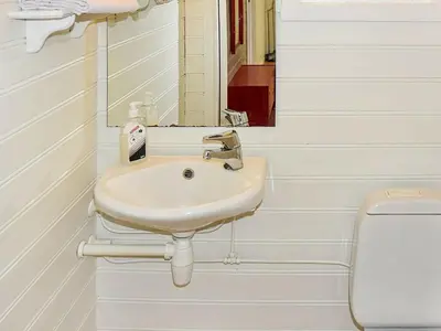 a bathroom with a sink and a toilet at 6 person holiday home in Aukra in Aukra