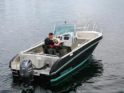 a man in a boat on the water at 6 person holiday home in Aukra in Aukra