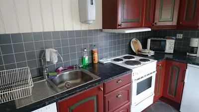 a kitchen with a sink and a stove at Lunde Turiststasjon in Skei