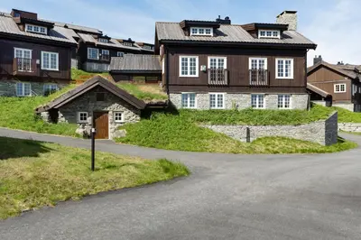 a road in front of a large house at Havsdalsgrenda Geilo Apartments in Geilo