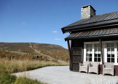 a group of chairs sitting outside of a building at Havsdalsgrenda Geilo Apartments in Geilo