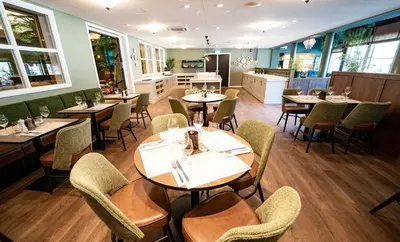 a restaurant with tables and chairs in a room at Hotel Aurlandsfjord in Aurland