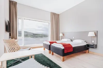 a hotel room with a bed and a large window at Wood Hotel by Frich's in Brumunddalen